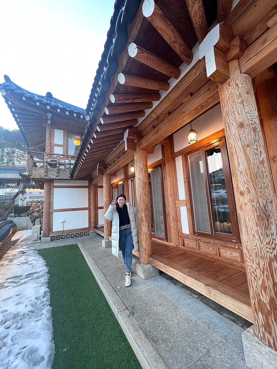 韩屋屋檐与木质门窗前的冬季人像