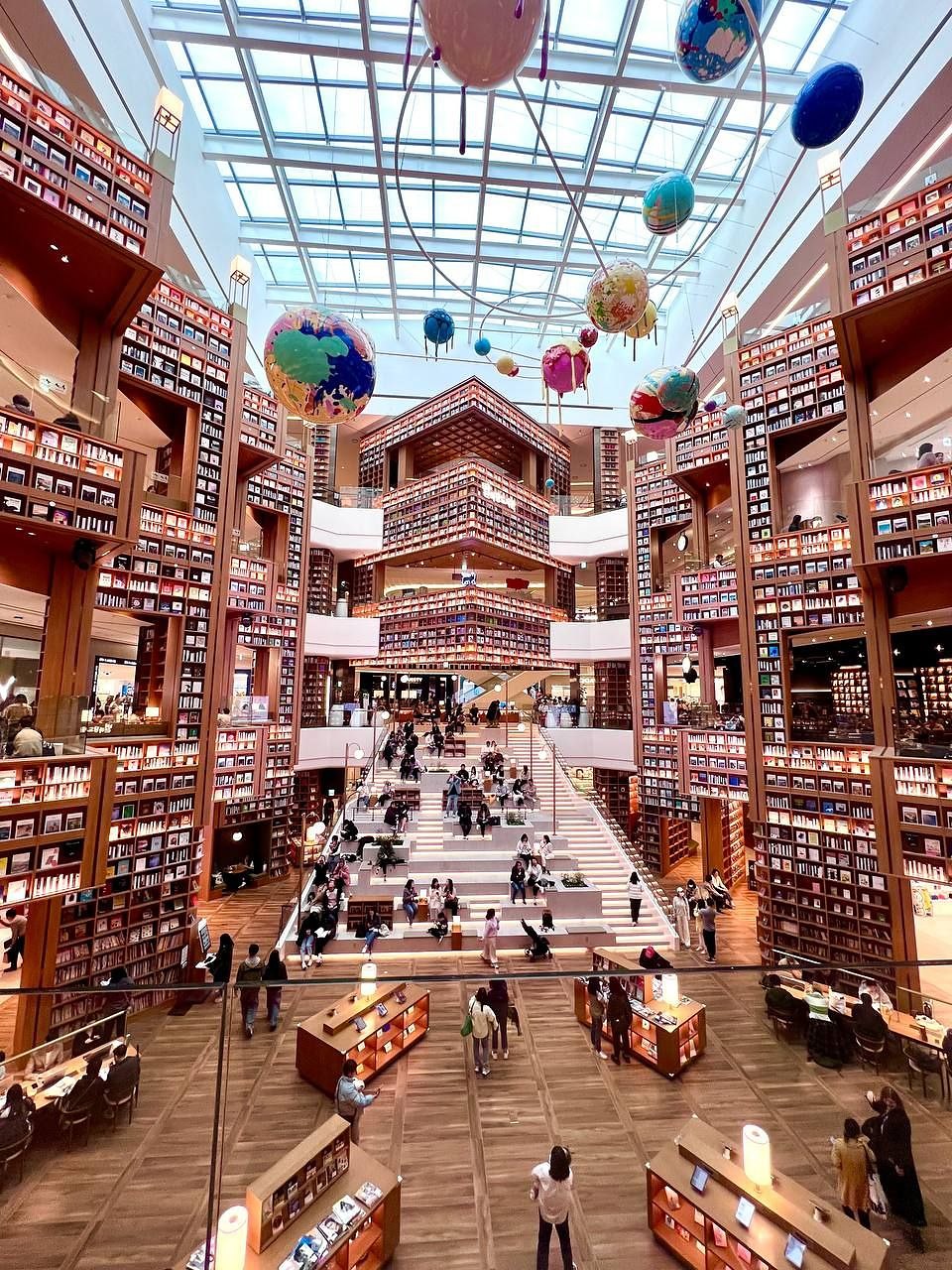 Wide view of the towering bookshelves and steps at Byeolmadang Library Starfield Suwon
