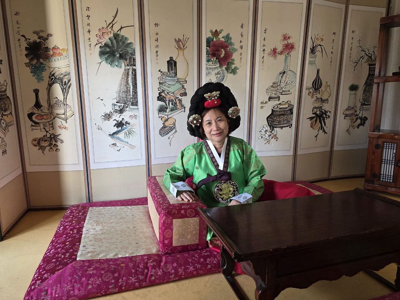 穿韩服在传统屏风前留影